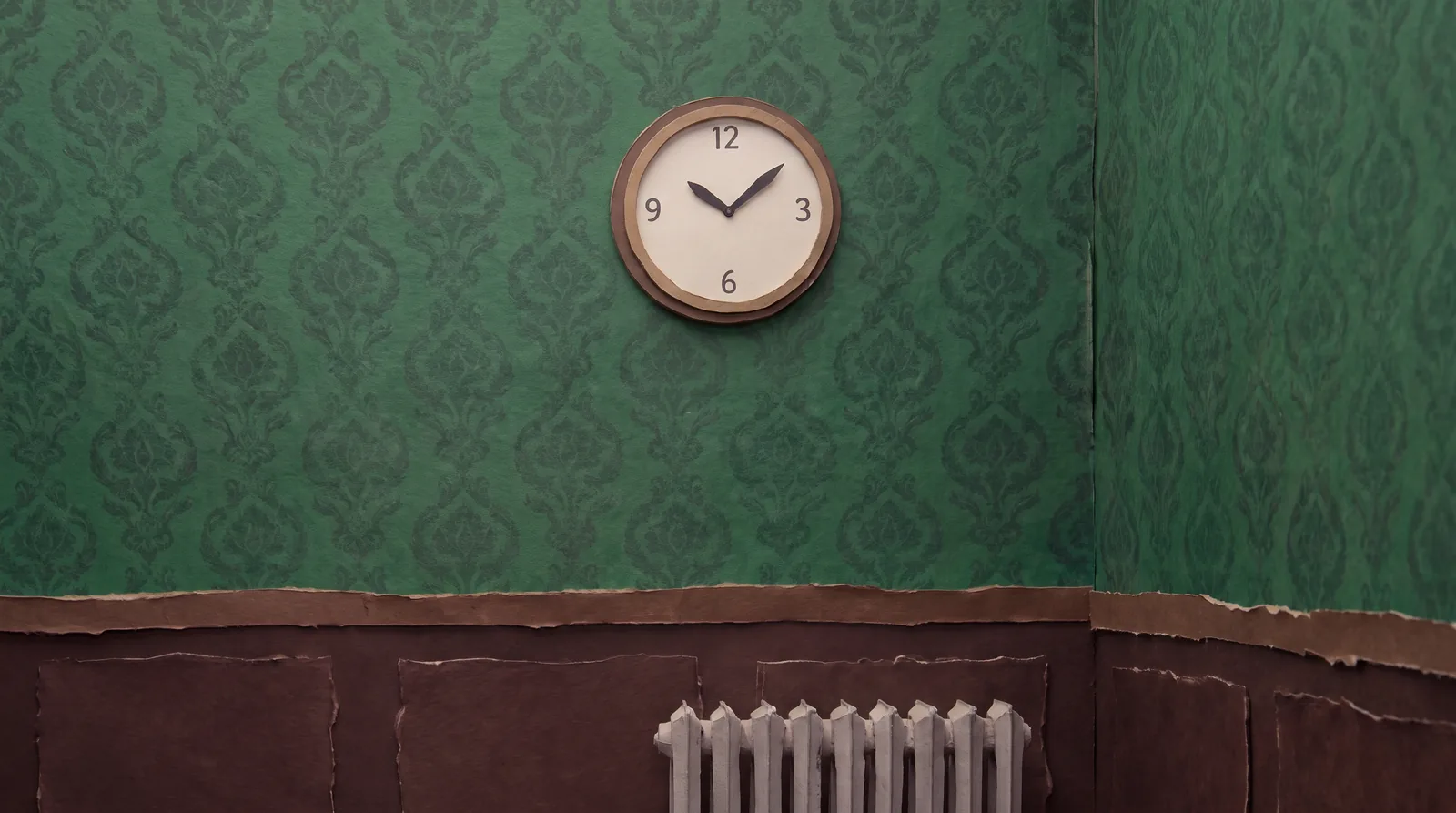 A clock on green damask, keeping time in the corner.